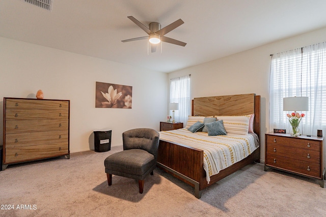 bedroom with carpet, visible vents, and a ceiling fan