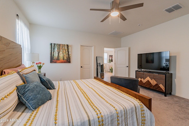 bedroom with a ceiling fan, visible vents, and carpet flooring