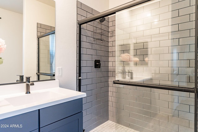 full bath with a shower stall and vanity