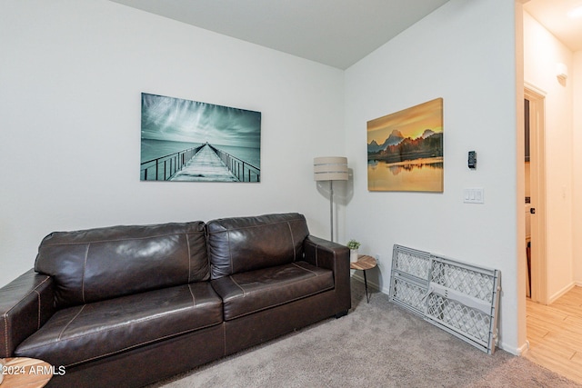 living area featuring carpet flooring and baseboards