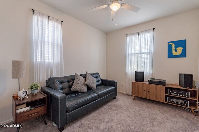 living room featuring carpet flooring, ceiling fan, and baseboards