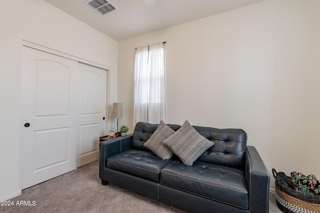 living area featuring carpet and visible vents