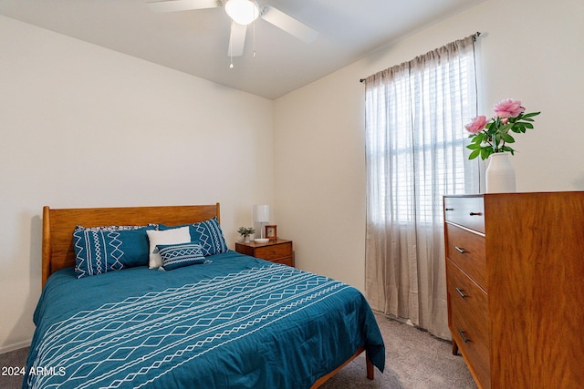 bedroom with a ceiling fan and light colored carpet