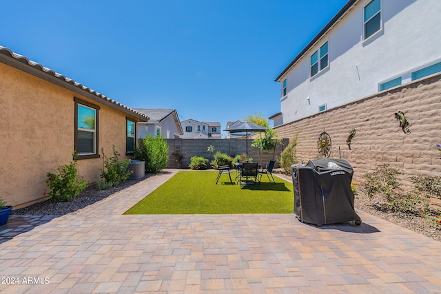 view of patio / terrace featuring a fenced backyard and a grill