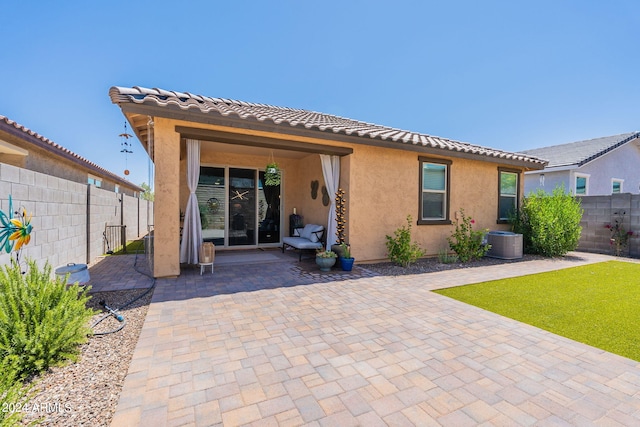 back of house featuring central air condition unit, a patio area, a fenced backyard, and stucco siding