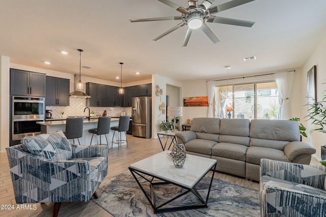 living room featuring light wood-style floors, recessed lighting, visible vents, and ceiling fan