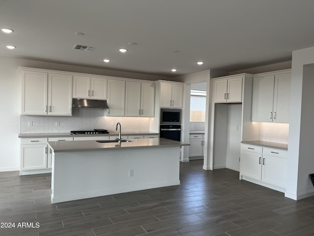 kitchen with white cabinetry, a kitchen island with sink, and appliances with stainless steel finishes