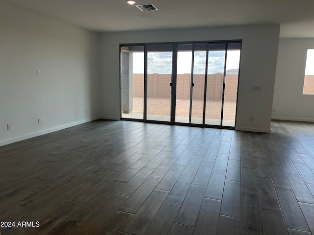 spare room with dark hardwood / wood-style flooring