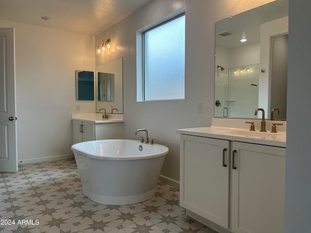 bathroom featuring vanity and independent shower and bath