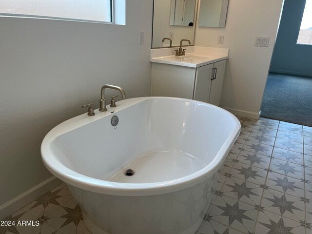 bathroom featuring vanity and a tub to relax in