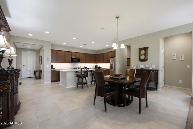 dining space with a chandelier, baseboards, recessed lighting, and light tile patterned flooring