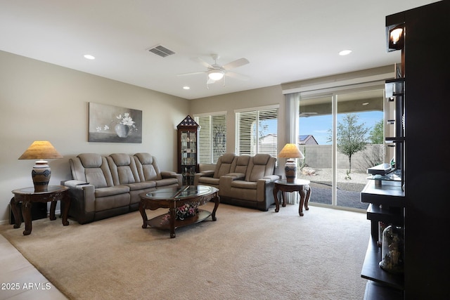 living area with visible vents, a ceiling fan, recessed lighting, and light carpet