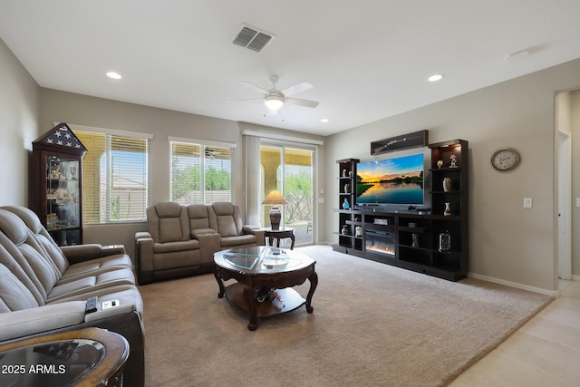 carpeted living room featuring baseboards, a ceiling fan, visible vents, and recessed lighting