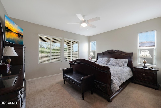 bedroom featuring baseboards, a ceiling fan, and light colored carpet