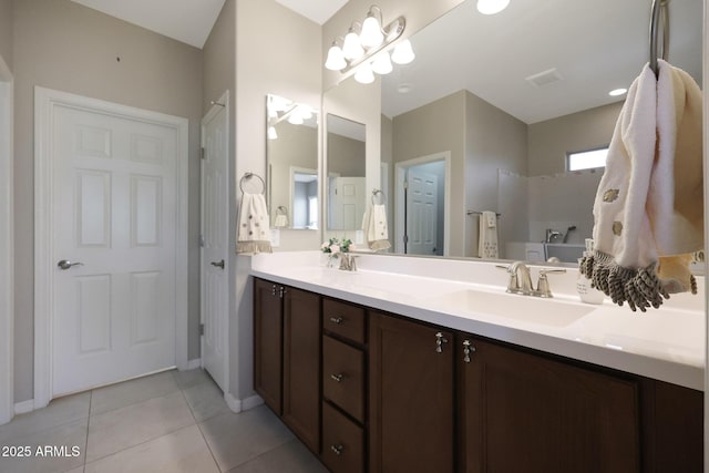 full bath featuring tile patterned floors, double vanity, a sink, and visible vents