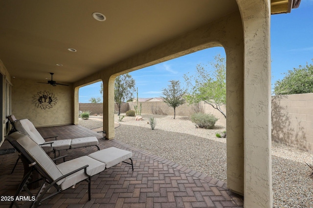 view of patio featuring a fenced backyard and a ceiling fan