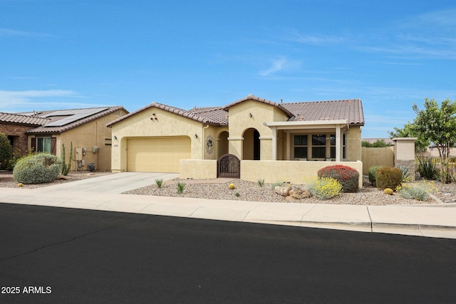 mediterranean / spanish home with stucco siding, fence, a tile roof, an attached garage, and concrete driveway