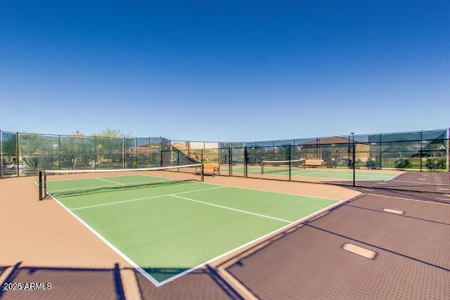 view of tennis court with fence