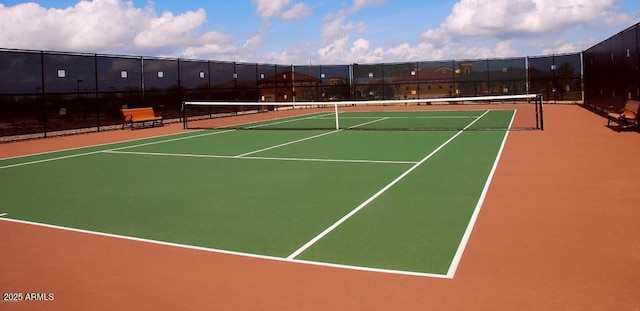 view of tennis court with fence and community basketball court