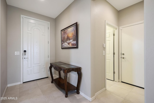 entrance foyer featuring light tile patterned floors and baseboards