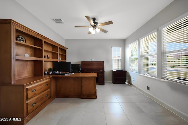 office area with light tile patterned flooring, baseboards, a ceiling fan, and visible vents