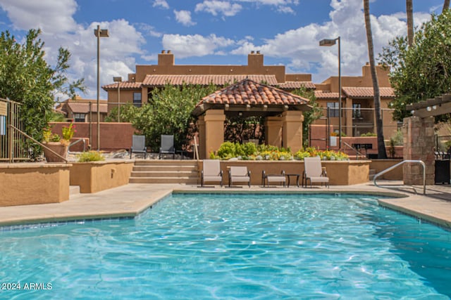 view of swimming pool with a gazebo and a patio