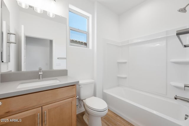 full bath with shower / washtub combination, toilet, vanity, and wood finished floors