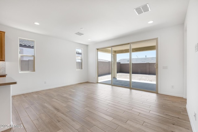 spare room featuring recessed lighting, visible vents, and light wood-type flooring