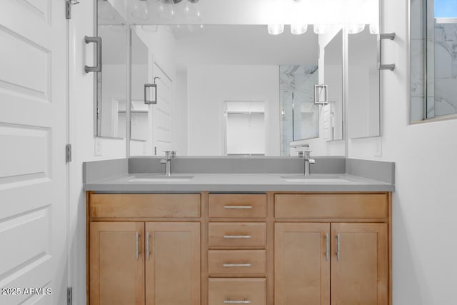 full bathroom with double vanity, a shower with door, and a sink