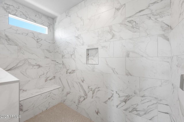 bathroom with tiled shower