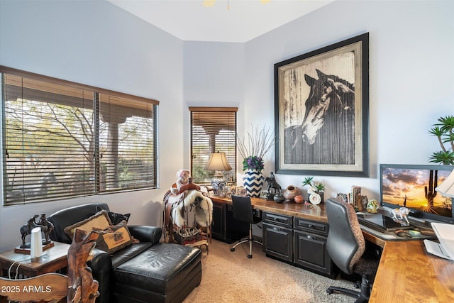 home office featuring light carpet and built in desk