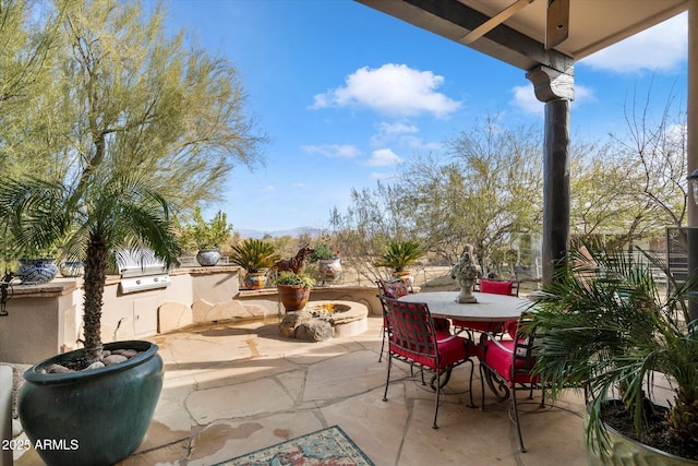 view of patio / terrace featuring a grill and a fire pit