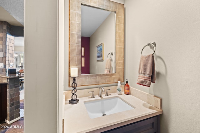 bathroom with vanity and decorative backsplash