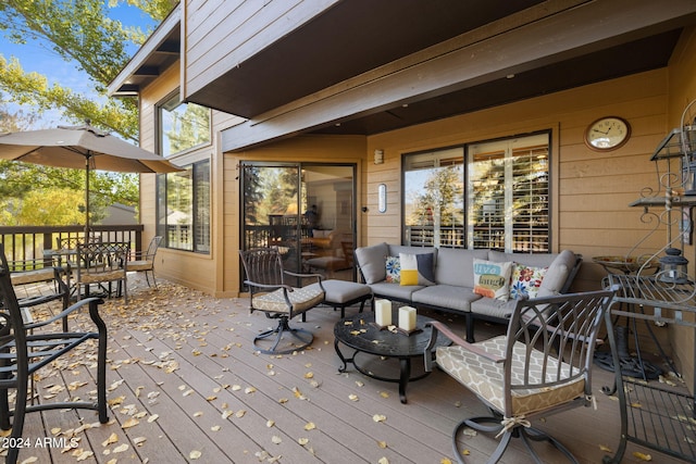 wooden terrace with an outdoor living space