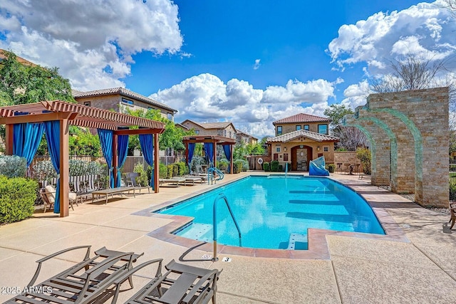 community pool featuring a patio, fence, and a pergola