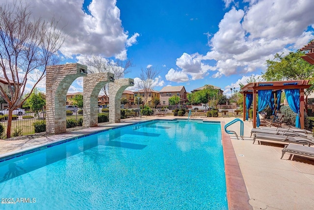 pool featuring a patio and fence