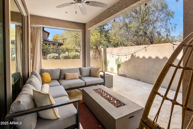 view of patio with ceiling fan, an outdoor living space with a fire pit, and a fenced backyard