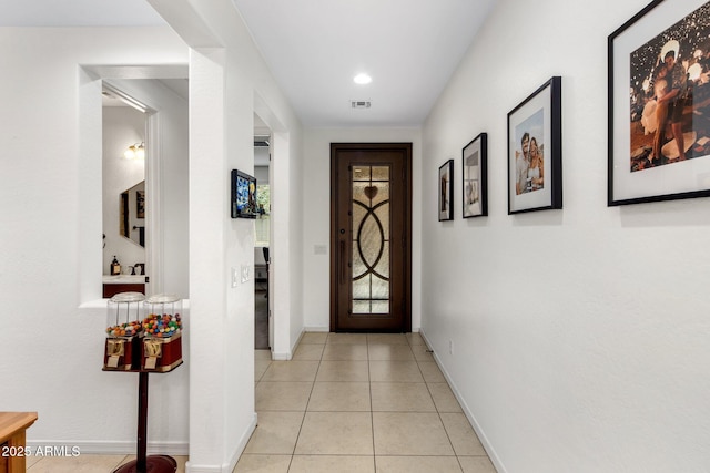 doorway featuring light tile patterned floors, visible vents, recessed lighting, and baseboards