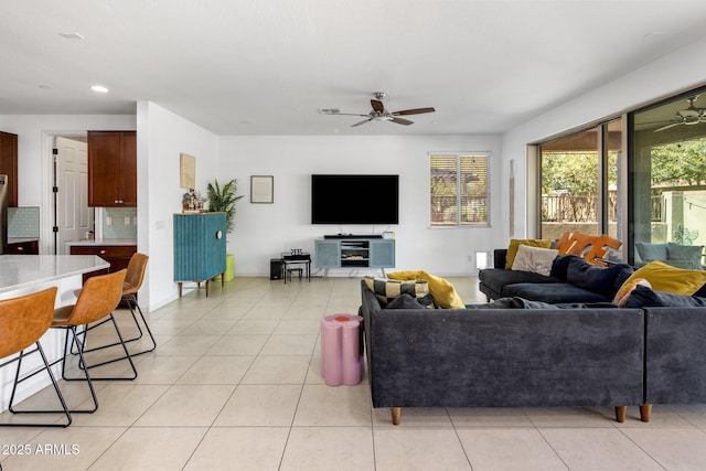 living area featuring light tile patterned floors, ceiling fan, and recessed lighting