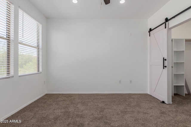 20100 N 78th Pl Unit 2114, Scottsdale, AZ 85255 - unfurnished bedroom with a barn door, carpet, multiple windows, and recessed lighting