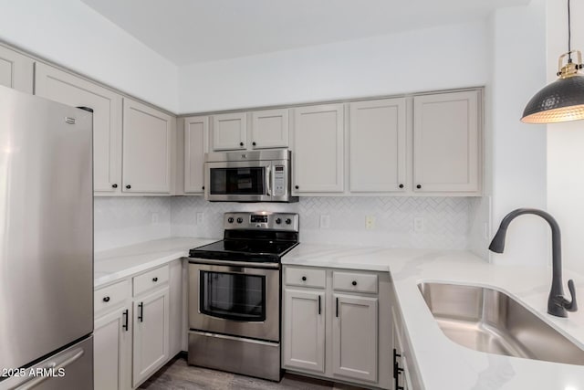 20100 N 78th Pl Unit 2114, Scottsdale, AZ 85255 - kitchen featuring stainless steel appliances, tasteful backsplash, light stone counters, and dark wood finished floors