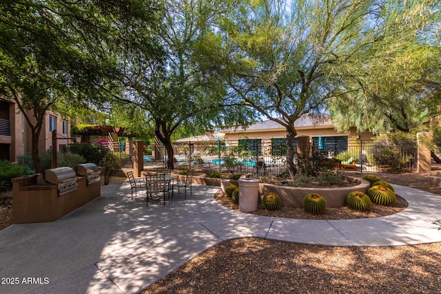 20100 N 78th Pl Unit 2114, Scottsdale, AZ 85255 - view of community featuring a patio and exterior kitchen