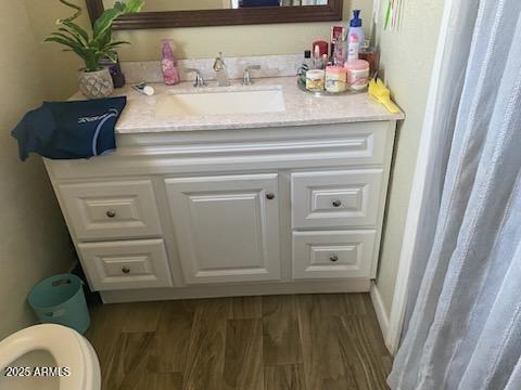 3431 W Campbell Ave, Phoenix, AZ 85017 - bathroom with vanity, wood finished floors, and toilet