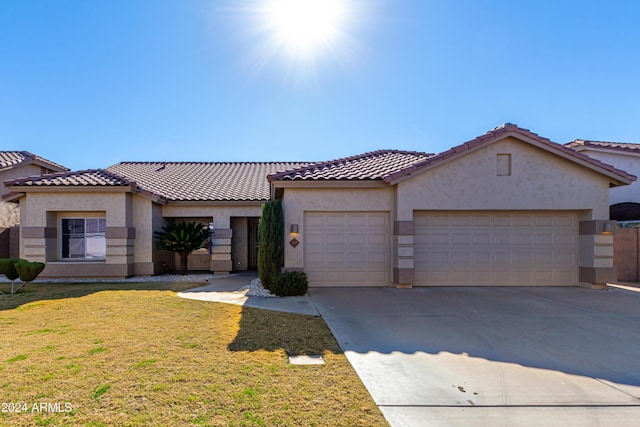 mediterranean / spanish home with a garage and a front yard