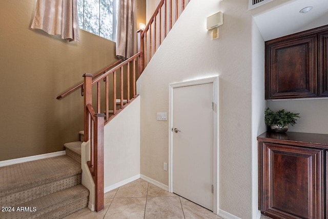 staircase with tile patterned floors