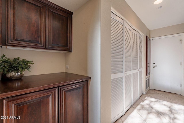 hallway featuring light tile patterned floors