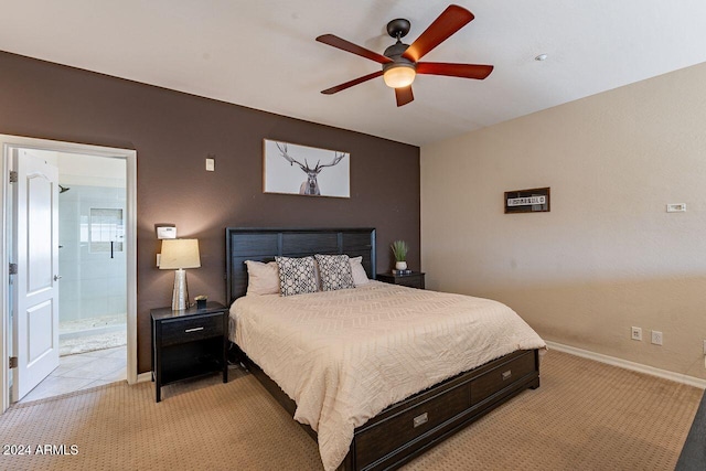 bedroom featuring ensuite bath, ceiling fan, and light carpet