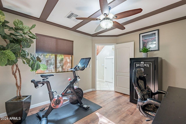 workout room with ceiling fan and light wood-type flooring