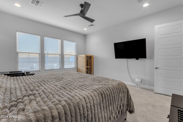 bedroom with ceiling fan and light carpet