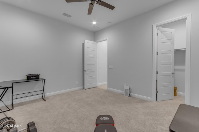 interior space with ceiling fan and light colored carpet